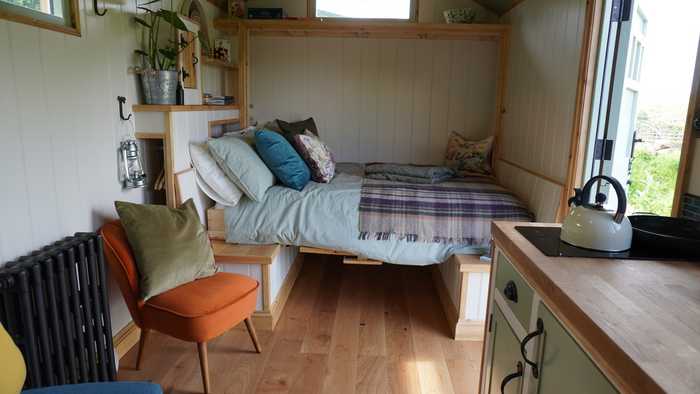 Inside Willow, self-contained shepherds hut. Bed converts to table